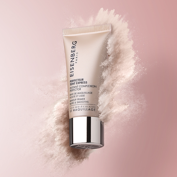 complexion perfector surrounded by beige powder and against pink background