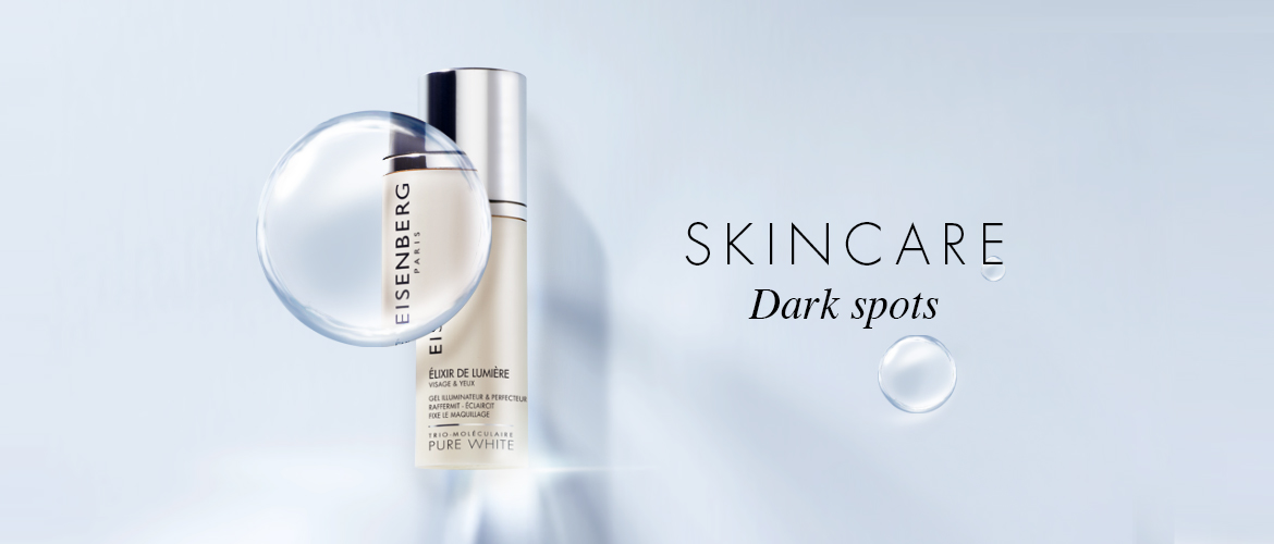 dark spot skincare and its magnifying bubble on a very brigh blue-grey bakground